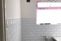 Bathroom gut and hack off all old tiles and build material. Render internal walls, dot n dab Moisture plasterboard to wall area. Re-plaster all walls and ceiling areas.