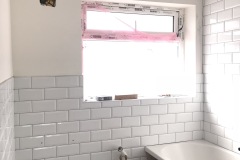 Bathroom gut and hack off all old tiles and build material. Render internal walls, dot n dab Moisture plasterboard to wall area. Re-plaster all walls and ceiling areas.